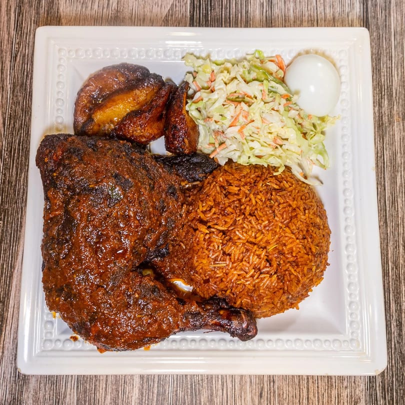 Dalia's African Cuisine: Jollof rice, grilled chicken, plantains, coleslaw, and a hard-boiled egg.