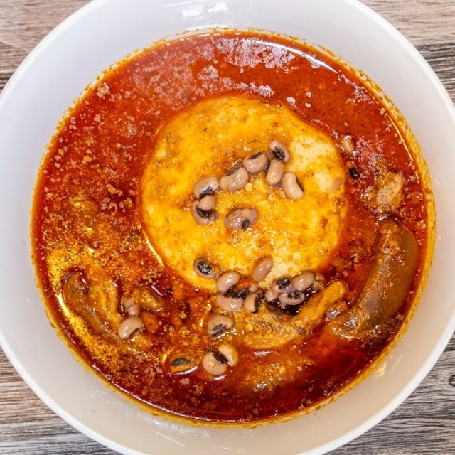 D15. Peanut & Palm Nut Soup with Rice Balls.